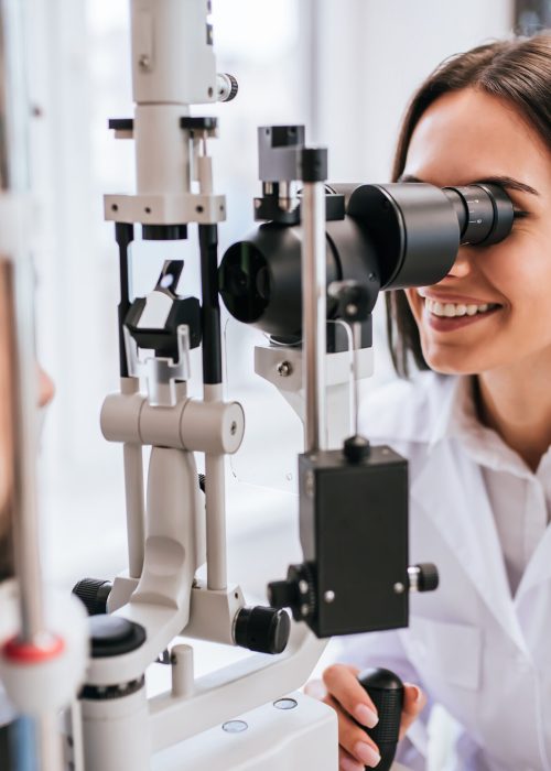 Attractive,Female,Doctor,Ophthalmologist,Is,Checking,The,Eye,Vision,Of Attractive,Female,Doctor,Ophthalmologist,Is,Checking,The,Eye,Vision,Of